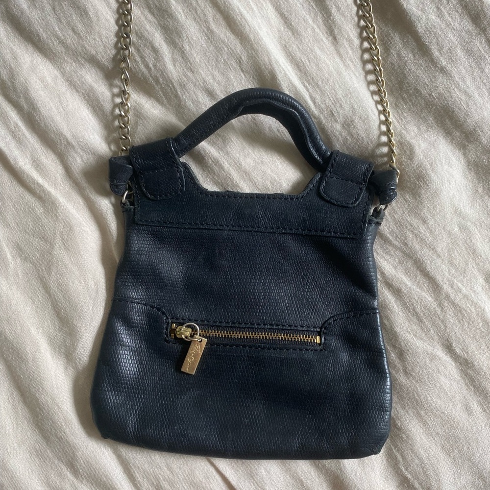 Mini Foley + Corinna crossbody black snake leather bag.